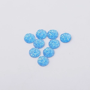 Macro view of 12mm blue resin drusy cabochons with sparkling mineral texture