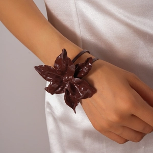 Detail of a chocolate brown double-layered flower bangle with glossy lacquer finish