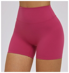Close-up of high-waist yoga shorts in rose red with vertical ribbed texture fabric