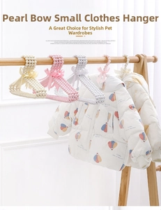 Close-up of pearl bead pet hangers with silk bows in white, pink and beige colors