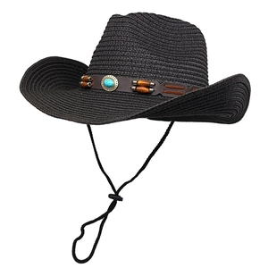 Detail of black straw cowboy hat with ethnic leather band and turquoise bead decor