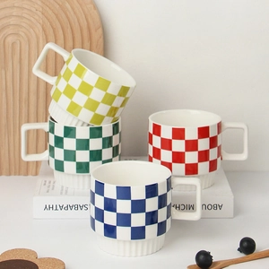 Minimalist ceramic plaid coffee mugs in four colors stacked on a modern wooden tray