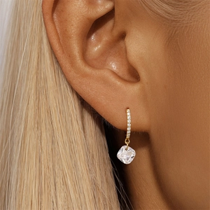 Close-up of gold S925 sterling silver hoop earring with rectangular cubic zirconia