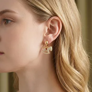 Elegant rocking horse stud earrings with gold plating, sparkling crystals, and red pearl