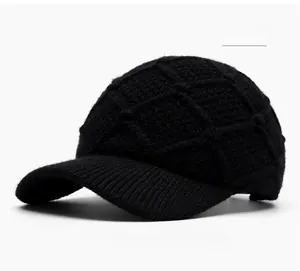 Close-up of black knitted baseball cap showing thick textured knit pattern and ribbed brim