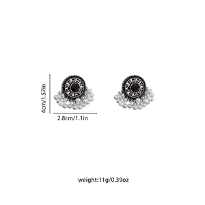Detail view of ethnic pearl earrings with size dimensions 4cm height and 2.8cm width