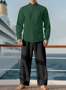 Detail of dark green cotton linen shirt and black trousers set on a cruise ship deck