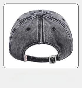Detailed back view of washed denim cap featuring silver buckle and red logo tag