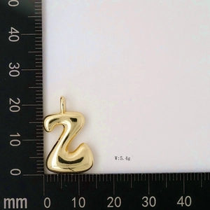 Detailed view of bubble initial Z pendant in gold with measurement scale and weight