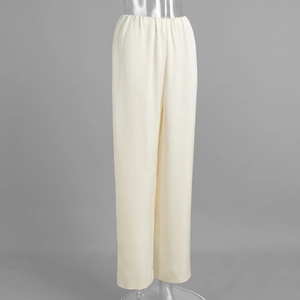 Close-up of cream satin wide-leg trousers showing the elastic waistband and silky texture