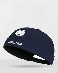Detail of white DINGHAN letter embroidery on navy blue cotton canvas docker hat