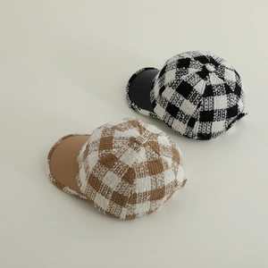 Detailed macro view of plaid wool baseball caps with leather brims for boys
