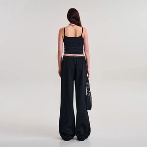 Rear view of women's black cotton wide-leg joggers with a matching strap crop top