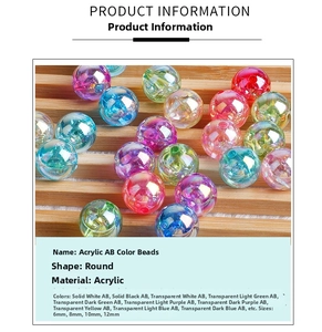 Detailed view of colorful acrylic AB beads in 6-12mm sizes on a wooden tray
