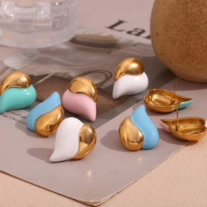 Macro detail of heart-shaped 18K gold-plated earrings with colorful enamel dripping finish