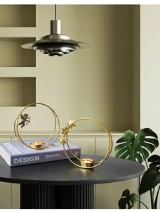 Detailed view of modern gold metal hoop candle holder with cupid and star decorations