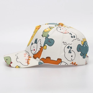Detail of children's white cotton baseball cap with colorful dinosaur patterns and curved brim