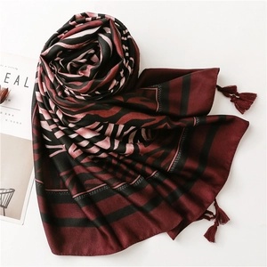 Detail of silk scarf showing bohemian zebra pattern and handmade tassel fringe trim