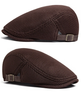 Detail of dark brown mesh beret with bronze adjustable buckle and breathable fabric