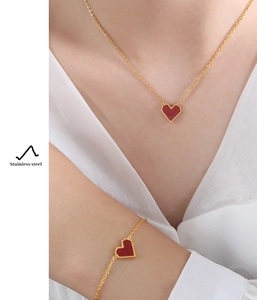 Detail of 18K gold plated stainless steel jewelry set with red heart shell pendants