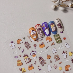 Macro detail of Halloween nail stickers featuring cartoon pumpkins, ghosts, and mummies