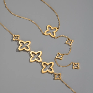 Detailed shot of golden hollow clover charms connected on a refined necklace chain