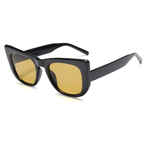 Retro cat-eye sunglasses with thick black frame and transparent yellow lenses in front view
