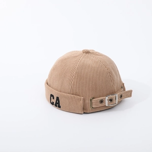 Detail of khaki corduroy brimless docker hat with black CA embroidery and metal buckle