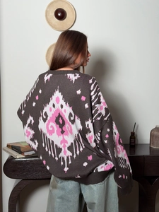 Close-up of bohemian geometric knit pattern on back of oversized brown wool sweater