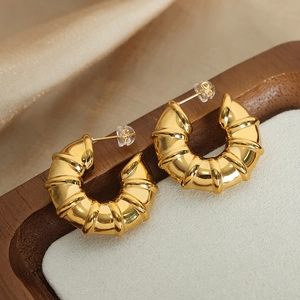 18k gold plated stainless steel C-shaped croissant earrings on a luxury jewelry box