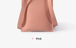 Close-up of pink leather phone bag showing precise stitching and shoulder strap details