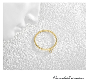 Detailed macro view of gold-plated ring with micro-inlaid four-prong zircon stone