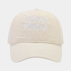 Detail of beige cotton baseball cap featuring high-quality CUTE BUT PSYCHO 3D embroidery