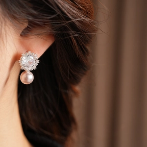 Detailed close-up of zircon square flower earrings with elegant pink pearl pendants