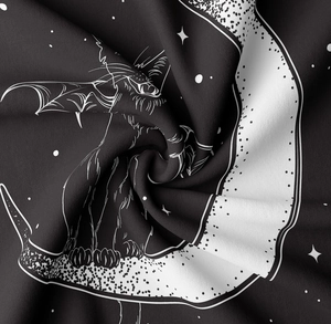 Macro detail of gothic black and white cat tapestry showing soft fabric texture and stars