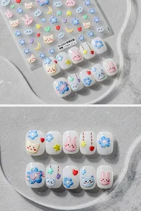 Detailed view of 5D embossed nail stickers featuring cute cartoon bunnies and floral patterns