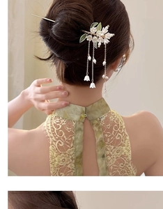 Detail of flower hair pin with pearl tassels worn with a green lace cheongsam
