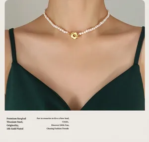 Close-up of pearl necklace with floral T-bar toggle clasp and 18K gold plated steel