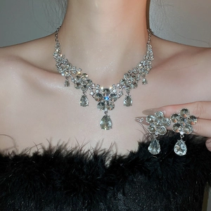 Detail of silver flower and water drop pendant necklace and earring set with crystals