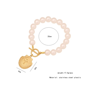 Detailed view of pearl necklace with gold shell pendant and measurements 20cm by 3cm