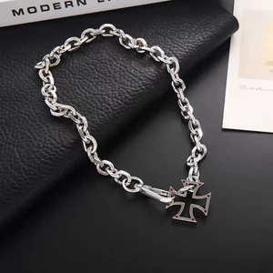 Silver cuban chain necklace with hollow cross pendant featuring red accents on dark background