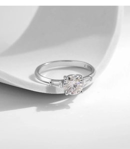 Detail of S925 sterling silver stamp on a 1 carat moissanite ring with side stones