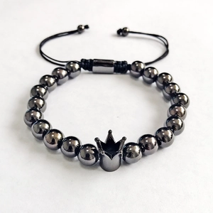 Detail of adjustable black beaded crown bracelet with professional braided drawstring design