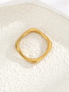 Detail shot of a minimalist gold square rounded ring with a matte metal finish