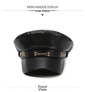 Close-up of black PU leather baker boy hat with decorative gold metal chain links