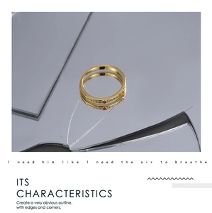 Detailed close-up of gold ring with red heart inlay and clear zircons on a reflective mirror