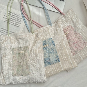 Detail of canvas tote bags featuring delicate floral lace pockets in pastel color options