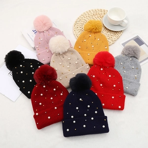 Women's warm winter knit beanie with faux fur pom pom and pearl embellishments in various colors