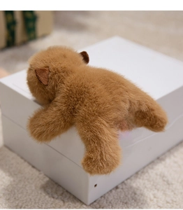 Close-up of soft fluffy brown plush capybara magnet with realistic faux fur texture