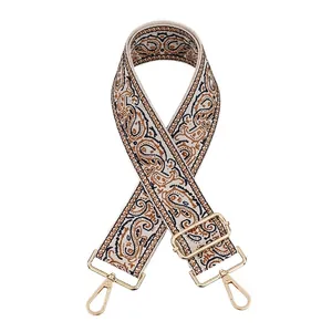 Detail of vintage paisley jacquard purse strap with golden metal swivel hooks